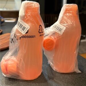 Two Tupperware Orange Plastic Bottles